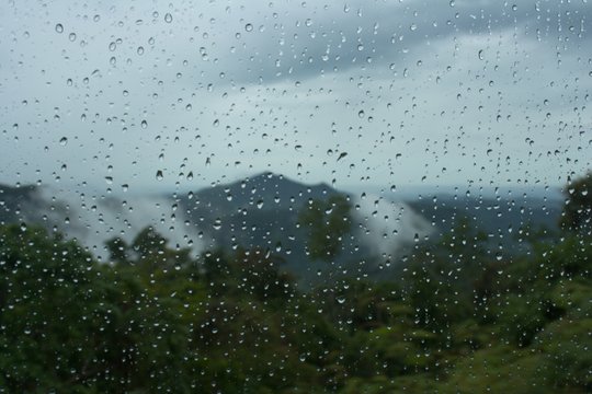 Fototapeta Moinsoon rain drops on the bus window glass