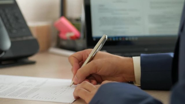 Businessman signing a contract, 4k UHD 2160p, dolly slider shot