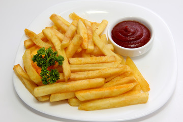 Fried potatoes with a cup of ketchup.