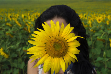 Cute girl in the field full of sunflowers sunlight. vintage tone, Selective focus on eye.