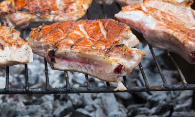 Grilled beef steak on the grill. grilling steaks on flaming grill and shot with selective focus