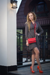 Obraz premium Beautiful redhead woman walking on the european street