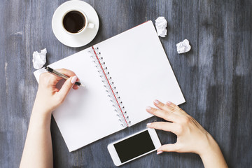 Woman writing in notepad closeup