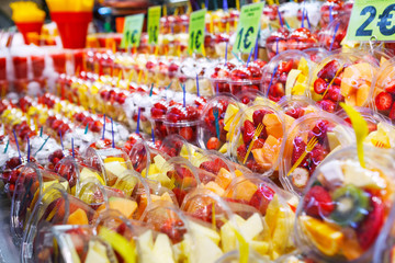 Fruit Salad arranged in plastic cups on a market