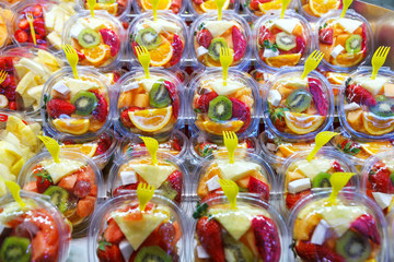 Fruit Salad arranged in plastic cups on a market