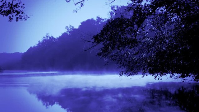 Blue morning fog on a calm river