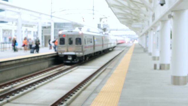 Young woman with suitcase on platform at the train station