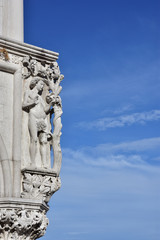 Doge Palace corner with ancient medieval sculpture of Adam and Tree of Knowledge