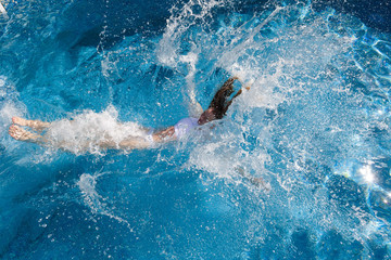 The girl in the pool lying on his back in the water