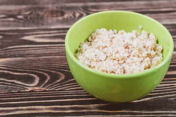 Oatmeal in Green Bowl on Wooden Table
