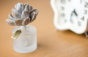 The love tag on perfume bottle and clock in background