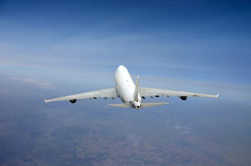 Fototapeta na wymiar Heavy jet airplane in flight from above