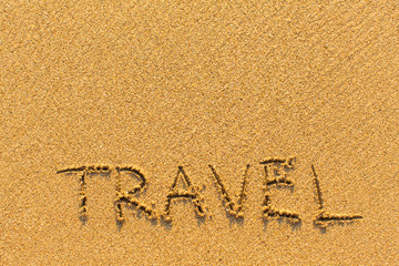 Travel - inscription on sand beach with the soft wave...