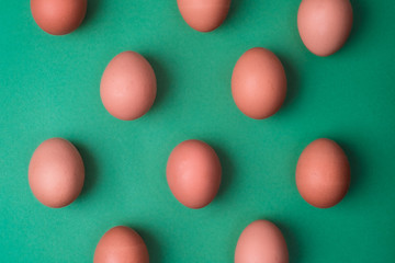 Eggs viewed from above on green background