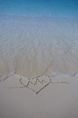 hearts drawn on the sand of a beach