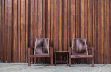 Fototapeta na wymiar wooden chair on the in front of the wall wood