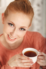 Ballerina drinking black tea and smiling