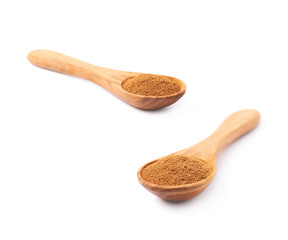 Wooden spoon full of cinnamon