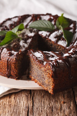 poppy seed cake with chocolate frosting and mint close-up. vertical
