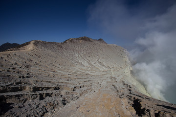 Sulfur mine with workers in Kawah Ijen, Java, Indonesia