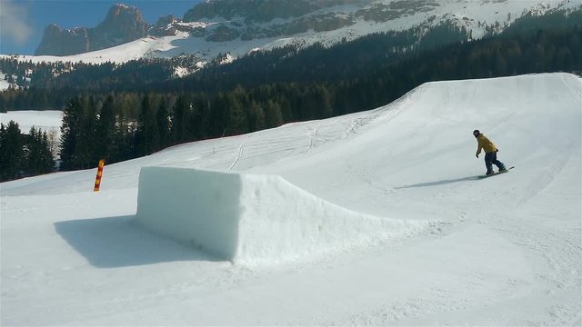 snowboarder jumps on kicker super slow motion