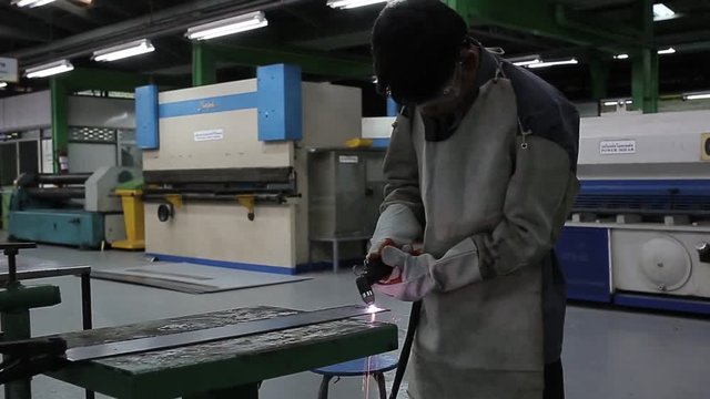 Welding worker in factory