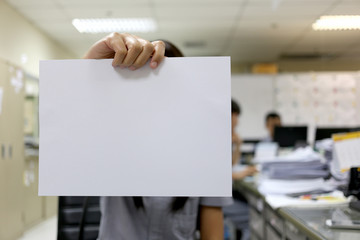 Woman's hand holding a blank white paper for input text to Desig