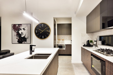 Modern kitchen countertop closeup with a stove and watch