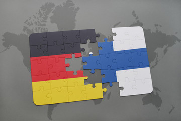 puzzle with the national flag of germany and finland on a world map background.