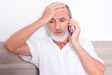Elderly man calling the doctor