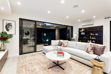 Modern living area with outside patio view at night