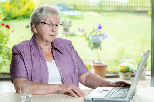 Female Senior Is Using Computer