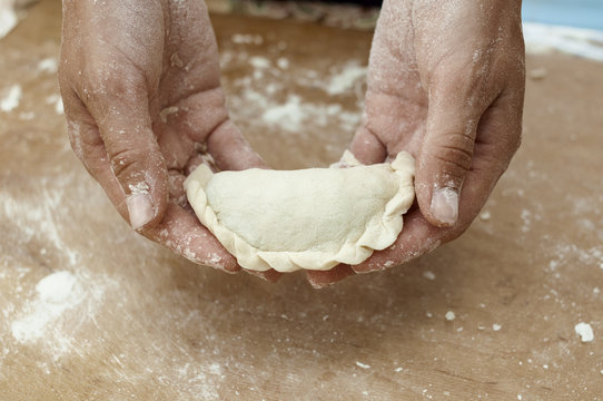 hands of the cook hold a product