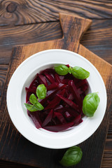 Above view of salad with beetroot and basil in a glass plate