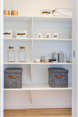 White wooden shelf included metal boxes and mugs with bottles