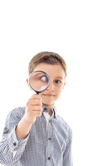 Closeup of a beautiful child looking through a magnifying glass