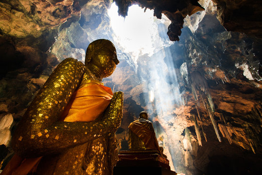 Buddha Statue in cave light rays
