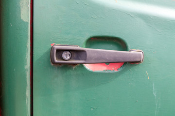 Close up of a black plastic car door handle