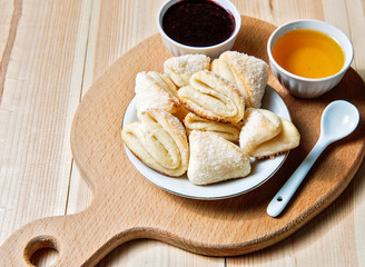Cheese cookies with honey and jam as a countryside breakfast