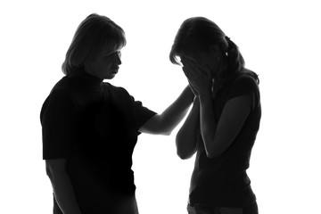 black and white silhouette of a loving mother who comforts the girl in distress