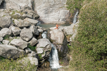 Man practicing yoga outdoors.