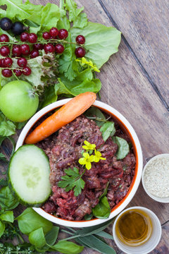 Liebevoll angerichteter Futternapf mit Barf f&uuml;r den Hund mit allen Zutaten wie Salat, Obst, Gem&uuml;se
