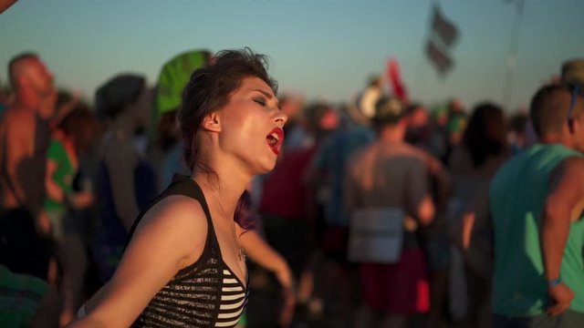 teen fan girl dance looking listening a concert of musical rock