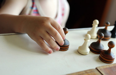 Cute toddler boy playing chess