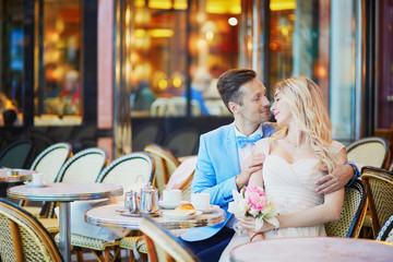 Just married couple in traditional Parisian cafe