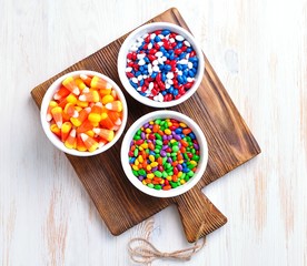 Multicolored candy sunflower seeds in the icing sugar and corn for Halloween.