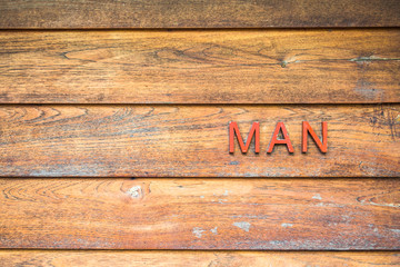 Man toilet sign on wooden background.