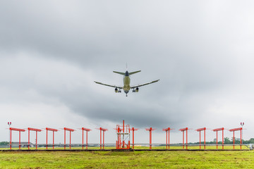 Airplane is landing at the airport before storm approaching.