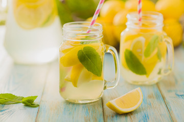 Fototapeta lemonade with mint on rocks served in jar with a straw obraz