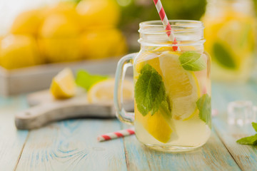 lemonade with mint on rocks served in jar with a straw